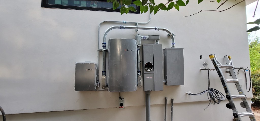 Enphase battery and electrical equipment installed on a home exterior wall