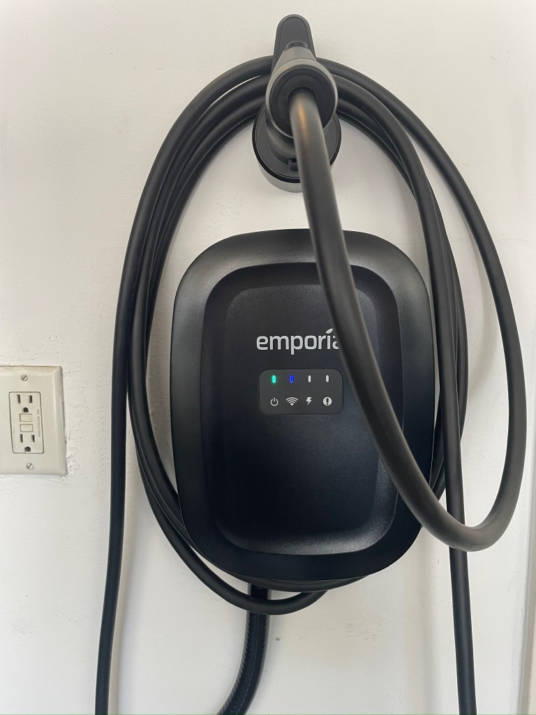 Emporia Level 2 EV charger installed on a white interior wall