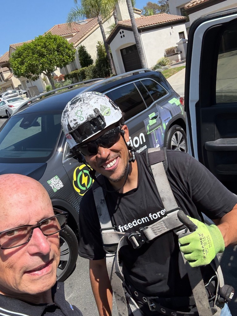 evNation crew member in safety gear giving a thumbs up on a residential job site