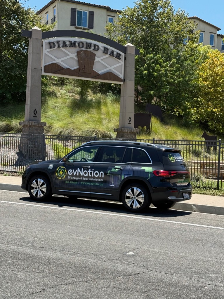 evNation branded service vehicle parked near the Diamond Bar city sign