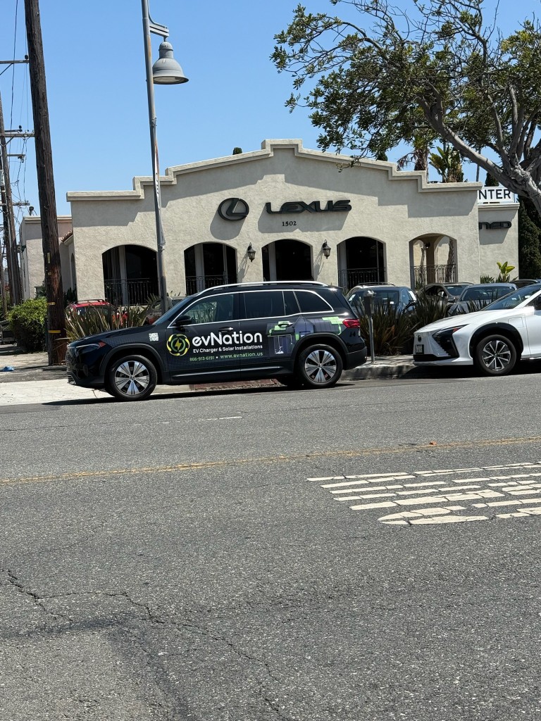 evNation branded service vehicle parked at a Lexus dealership